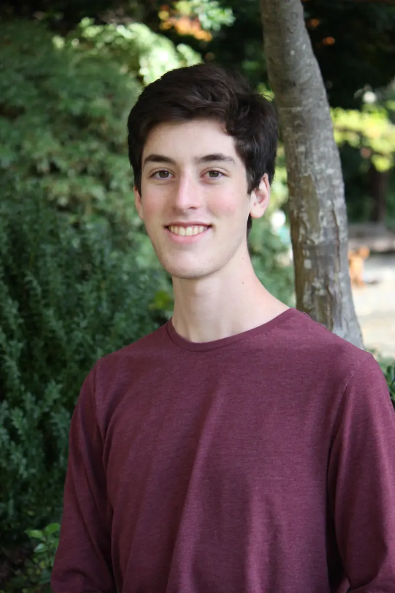 Photo of Jordan, looking handsome in a maroon shirt.